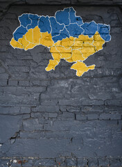 Wall Mural - Map of Ukraine in color of Ukrainian flag on the brick wall