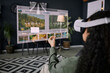 © AnnaStills - Over-the-shoulder shot of unrecognizable woman wearing VR headset sitting in living room surfing Internet
