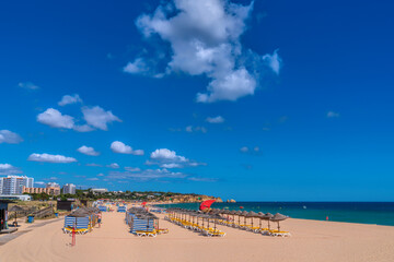 Sticker - Alvor Portugal beautiful sandy beach with umbrellas and sun loungers the Algarve between Portimao and Lagos