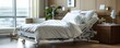 © Ruby Siam - Hospital bed with white linens in a modern room.
