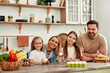 © Valerii Apetroaiei - A happy family cooking in a modern kitchen, bonding over meal preparation and enjoying quality time