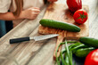 © Valerii Apetroaiei - Fresh and colorful vegetables are being chopped on a wooden cutting board in the kitchen