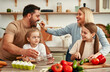 © Valerii Apetroaiei - Family cooking together in modern kitchen, enjoying meal preparation and quality time