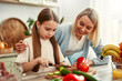 © Valerii Apetroaiei - Mother and daughter cooking together in a bright kitchen, enjoying creating meals side by side