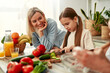 © Valerii Apetroaiei - Mother and daughter cooking together in a bright kitchen, enjoying creating meals side by side