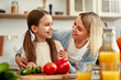© Valerii Apetroaiei - Mother and daughter cooking together in a bright kitchen, enjoying creating meals side by side
