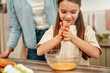 © Valerii Apetroaiei - A mother and daughter bond while baking in their kitchen, enjoying the activity together