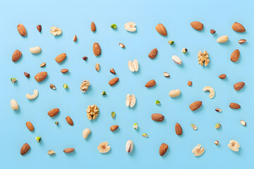 Canvas Print - Colorful nuts scattered on electric blue background