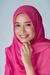 Wall Mural - A beautiful woman in pink hijab smiling.