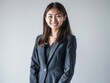 © VISUAL BACKGROUND - A young woman in a business suit posing for a photo.