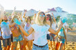 © maxbelchenko - Holi festival. Young people with colorful paint on clothes and bodies have fun together. Beach party. Friendship, rest, holidays.