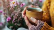 © OnuTH - A close-up of a hand holding a cup of herbal tea, representing the comforting and health-promoting effects of herbal remedies.