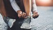 © peopleimages.com - Gym, hands and person tie shoes to start exercise, training or workout at health club closeup on floor. Legs, athlete and tying lace on sneakers to prepare or get ready for sport, fitness or wellness
