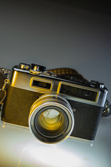 An old rangefinder film camera on gray.