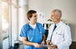 © peopleimages.com - Doctor, tablet and talking with male nurse in clinic, medical collaboration and together on telehealth or healthcare. Teamwork, speaking and professional research online, hospital update and results