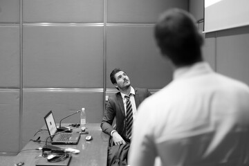 Wall Mural - Speaker giving a talk at business meeting. Business and Entrepreneurship concept. Black and white image.