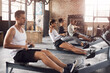 © ClearConcept/peopleimages.com - Fitness, gym and athletes on rowing machine for health, wellness and body workout with class. Endurance, exercise and group of people on ergometer equipment for cardio cross training in sports center