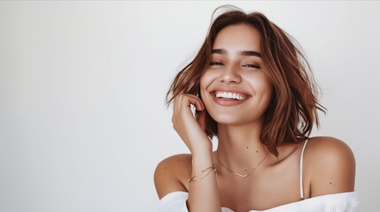 Wall Mural - A woman smiling with her hand on her ear.