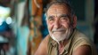 © VISUAL BACKGROUND - An older man is smiling while sitting outside.