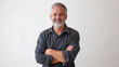 © Nataliia_Trushchenko - A man with a gray beard and a black shirt is smiling and crossing his arms. Concept of confidence and self-assurance