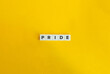 © photoopus - Pride Word. Text on Block Letter Tiles on Yellow Background. Minimalist Aesthetics.