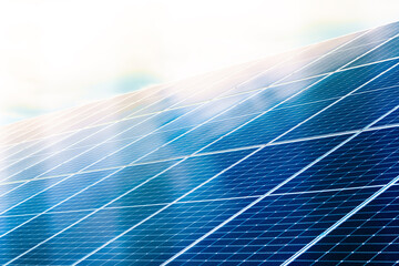 Solar panels close up with blue cloud reflection.