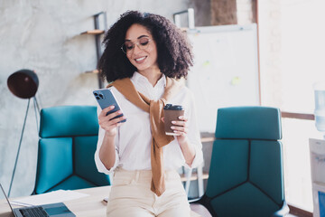 Wall Mural - Photo of nice successful business woman use smart phone drink coffee wear white shirt modern office indoors