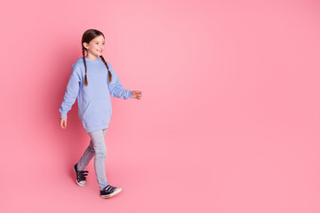 Canvas Print - Full body portrait of cute little schoolkid walk empty space wear hoodie isolated on pink color background