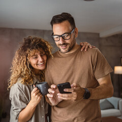 Wall Mural - Portrait of adult couple husband and wife use mobile phone together