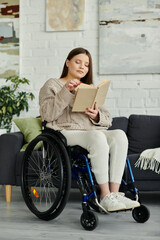 Wall Mural - A young woman in a wheelchair sits in her living room, engrossed in reading a book.