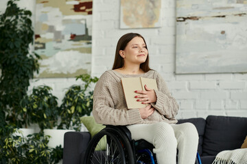 Wall Mural - A young woman sits in a wheelchair in her living room, holding a book close to her chest.