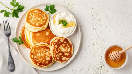 Wall Mural - Top view of a plate of crispy potato pancakes with sour cream and parsley, ready to be enjoyed