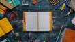 © AS Studio - An overhead view of a desk with scattered school supplies and a blank notebook