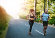 © peopleimages.com - Man, woman and running on mountain for fitness, exercise and together for wellness or cardio. Sunshine, couple and happy in nature for health, support and performance for marathon training in morning