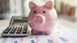 © Valentin - Financial Planning with Piggy Bank and Calculator on Graphs
