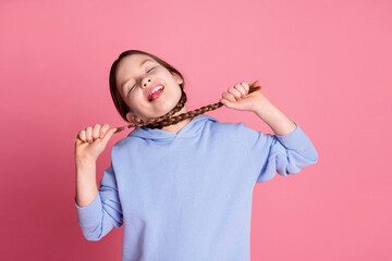 Poster - Portrait of cute little schoolkid braids choke neck wear hoodie isolated on pink color background