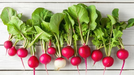 Wall Mural - Fresh organic red radishes with tops on white wooden background viewed from above