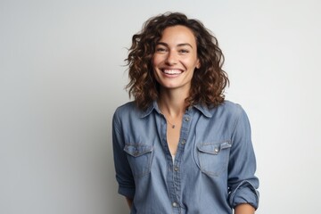 Wall Mural - Portrait of a blissful woman in her 30s sporting a versatile denim shirt isolated in white background