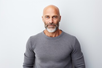 Wall Mural - Portrait of a satisfied man in his 40s showing off a thermal merino wool top isolated in white background