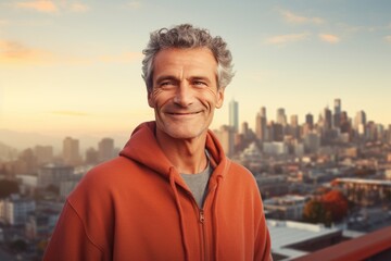 Poster - Portrait of a smiling man in his 50s dressed in a comfy fleece pullover isolated on vibrant city skyline