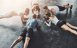 © peopleimages.com - People, fitness and plank in group at gym for workout, core exercise or training together indoors. Diverse class, friends and warm up for ab muscle, session and sport for health above gymnasium floor
