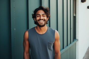 Sticker - Portrait of a grinning indian man in his 30s donning a trendy cropped top isolated in modern minimalist interior