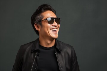 Wall Mural - Portrait of a joyful asian man in his 40s wearing a trendy sunglasses in front of modern minimalist interior