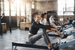 © peopleimages.com - Exercise, gym and woman on rowing machine for health, wellness and body workout with class. Endurance, fitness and female athlete on ergometer equipment for cardio cross training in sports center.