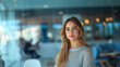 © GraysonStock - Portrait of a blonde businesswoman, looking straight ahead with a confident attitude, in a minimalist, modern office.