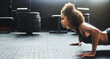 © peopleimages.com - Push up, fitness and woman for strength, arms and workout on gym floor for health. Muscle, bodybuilding and strong female person for exercise, training and routine for sports and cardio goals