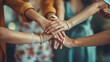 © Dennis - Teamwork, female team members putting their hands together in unity