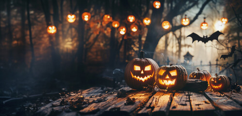 Wall Mural - Spooky halloween background with carved pumpkins on a rustic wooden table 