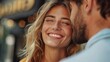 © Lens Legacy - A radiant couple sharing a loving moment in an urban setting, with the woman smiling brightly at her partner, capturing the essence of affection and happiness.