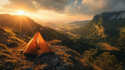 Wall Mural - A cozy tent set up on a hilltop, offering a panoramic view of a sprawling valley bathed in golden sunset light.